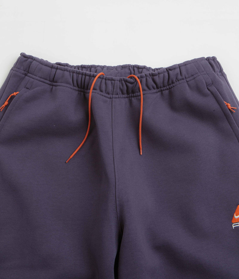 Nike ACG Tuff Fleece Lungs Pants in Dark Raisin and Safety Orange / Summit White