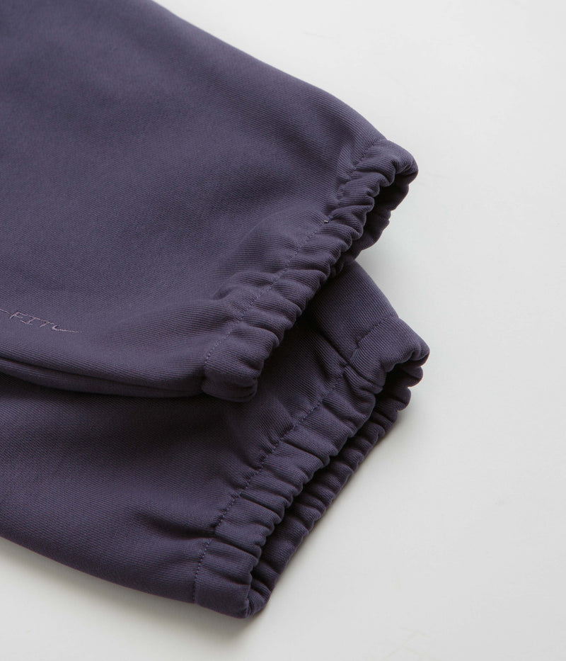 Nike ACG Tuff Fleece Lungs Pants in Dark Raisin and Safety Orange / Summit White